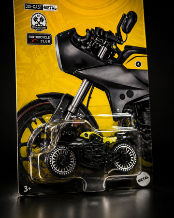 Close-up of die-cast metal motorcycle with studded wheels and side stand