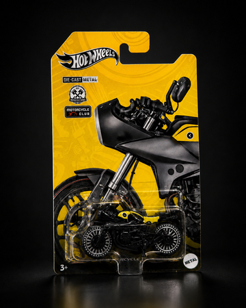Black and yellow die-cast bagger motorcycle collectible, studio front shot