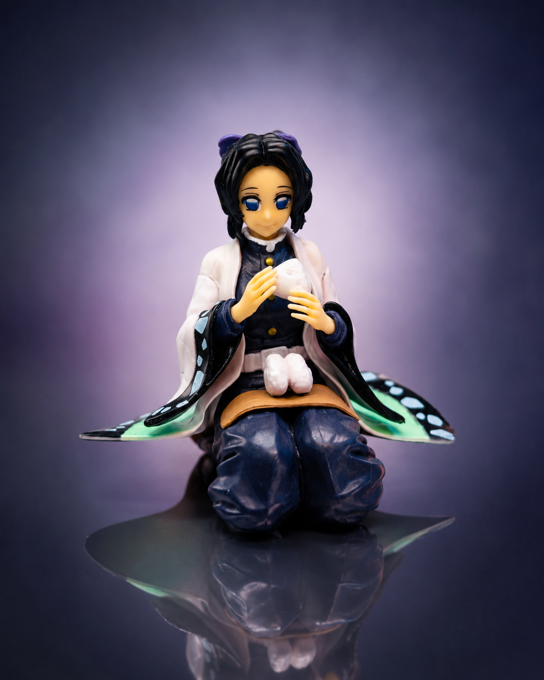 Shinobu Kocho sitting anime figure with rice ball and butterfly haori — front view
